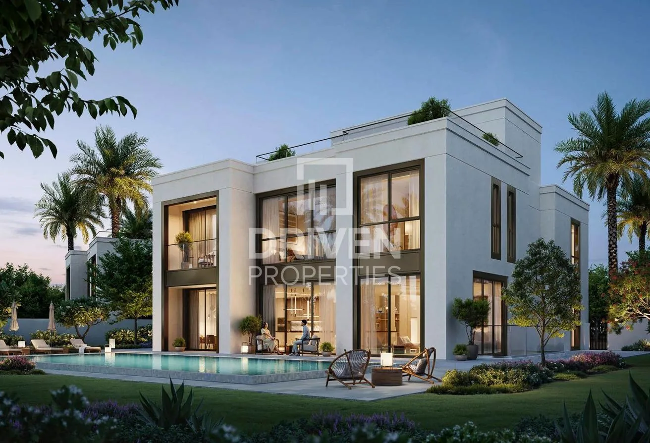 Rear elevation of the six bedroom villa with private pool and garden at dusk