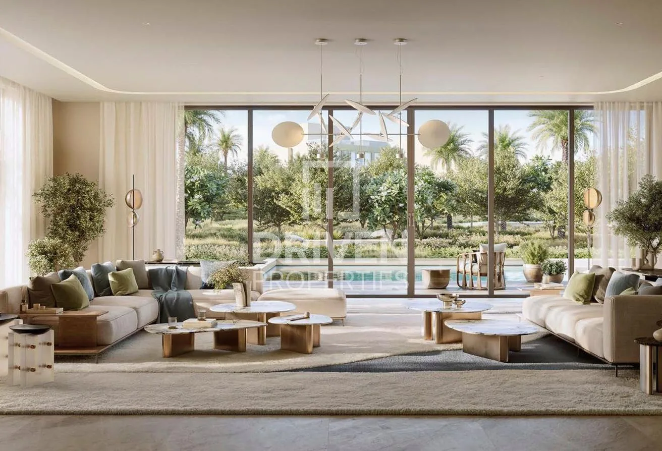 Bright open-plan living room glazed to the garden and pool