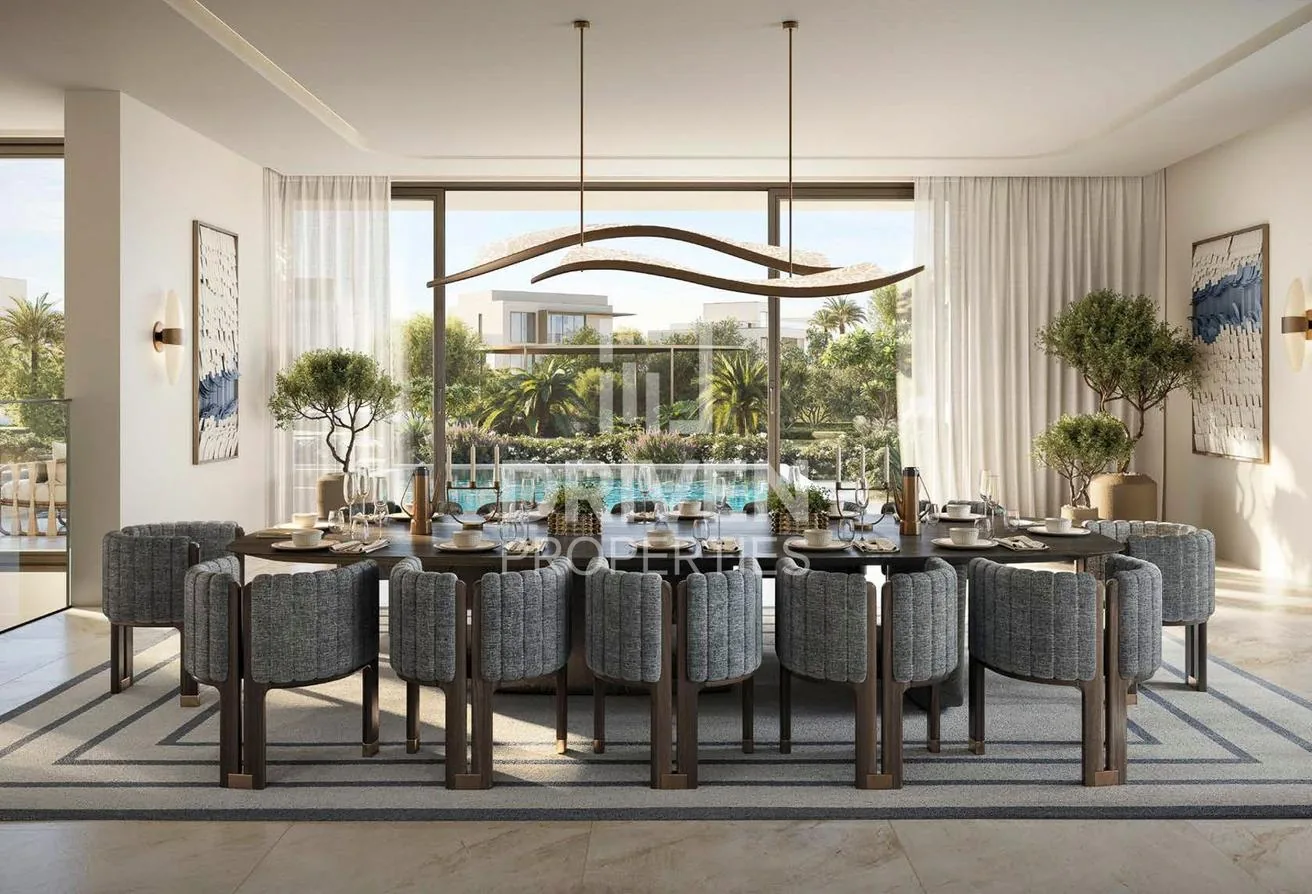 Formal dining room for twelve with a sculptural chandelier and a garden view