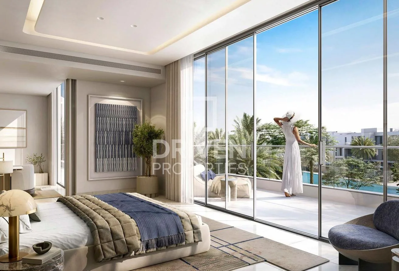 Primary bedroom suite opening to a balcony over the pool and lagoon