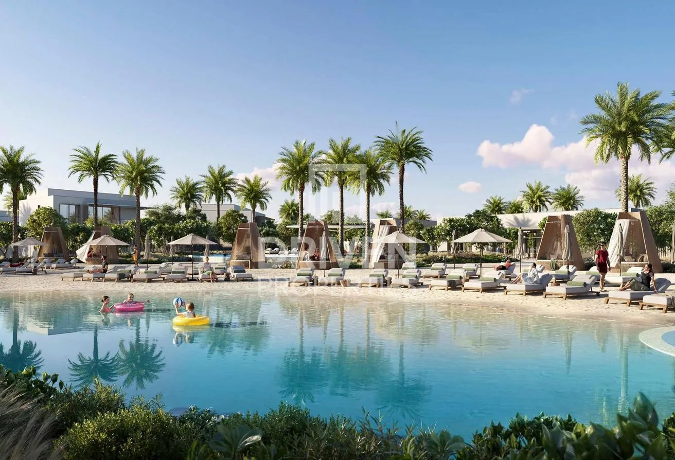 White-sand lagoon beach with cabanas and loungers at The Oasis
