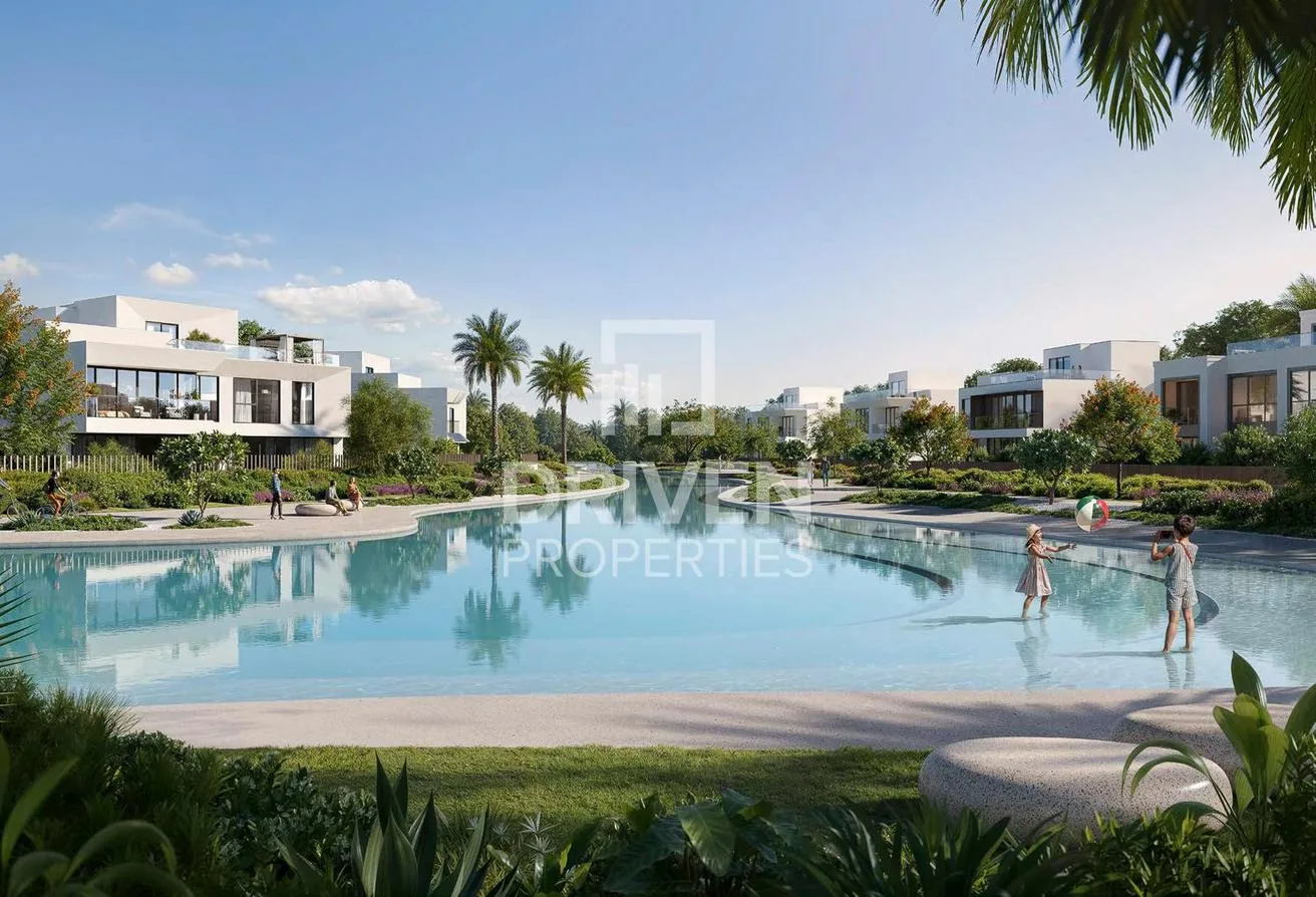Swimmable crystal lagoon with families and villas around the water