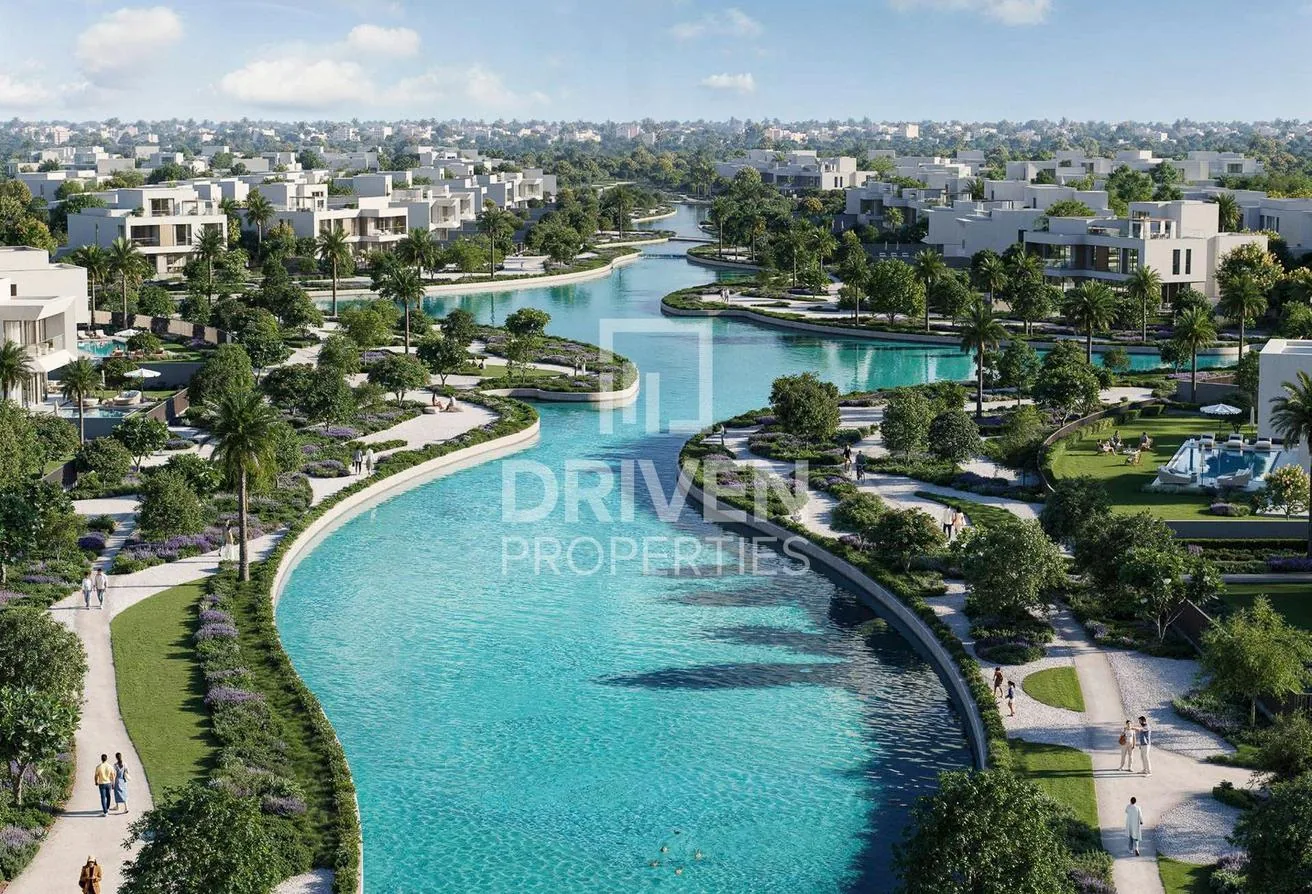 Aerial view of the winding lagoons and villas across The Oasis by Emaar
