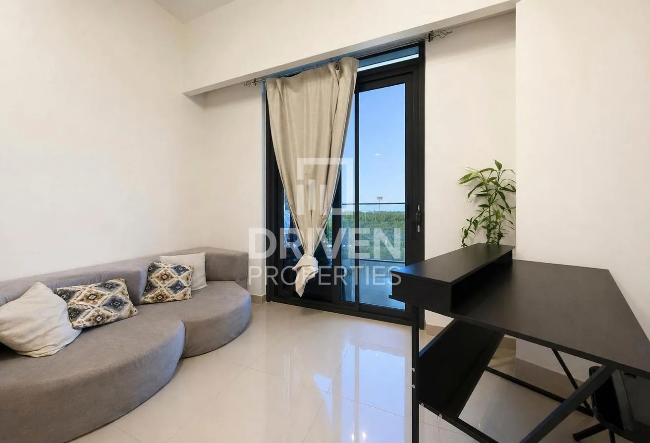 Living area with a sofa and full-height doors to the balcony