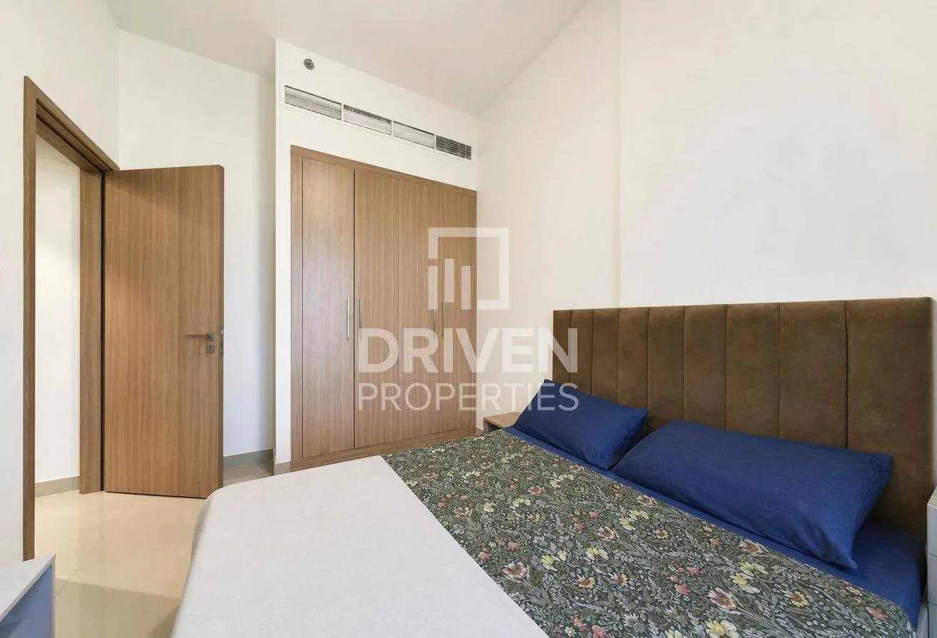 Bedroom with an upholstered bed and a full wall of built-in wardrobes