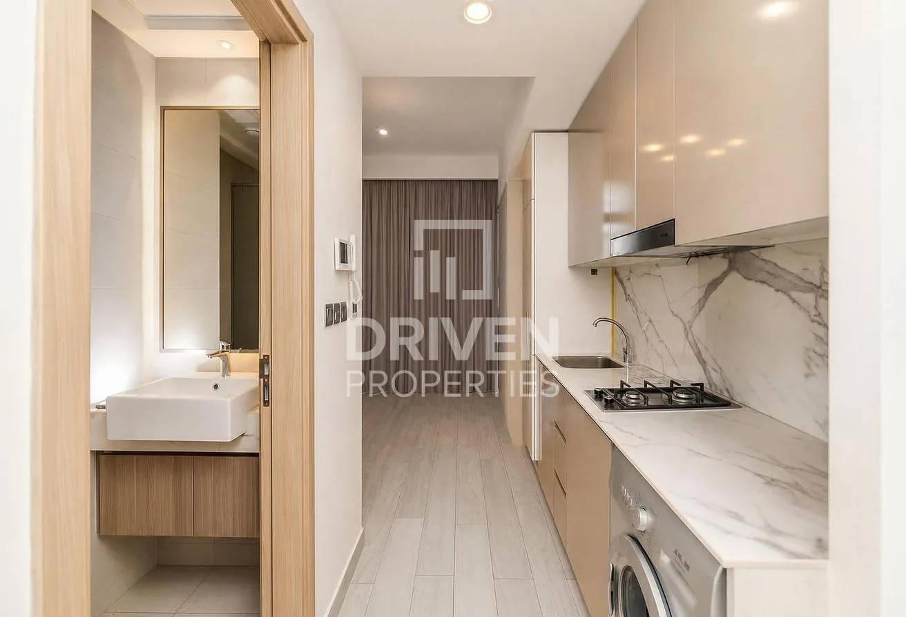 Studio layout showing the bathroom, galley kitchen and balcony beyond
