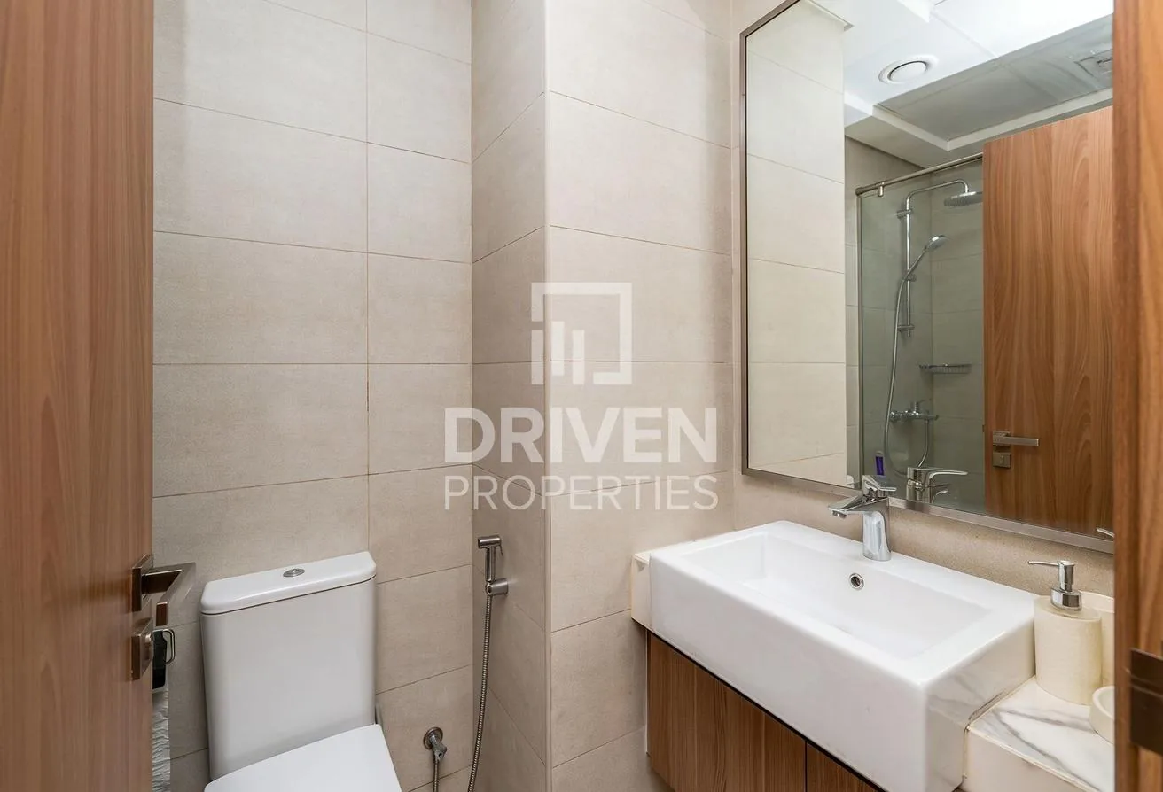 Bathroom with floating vanity, large mirror and rain shower behind glass