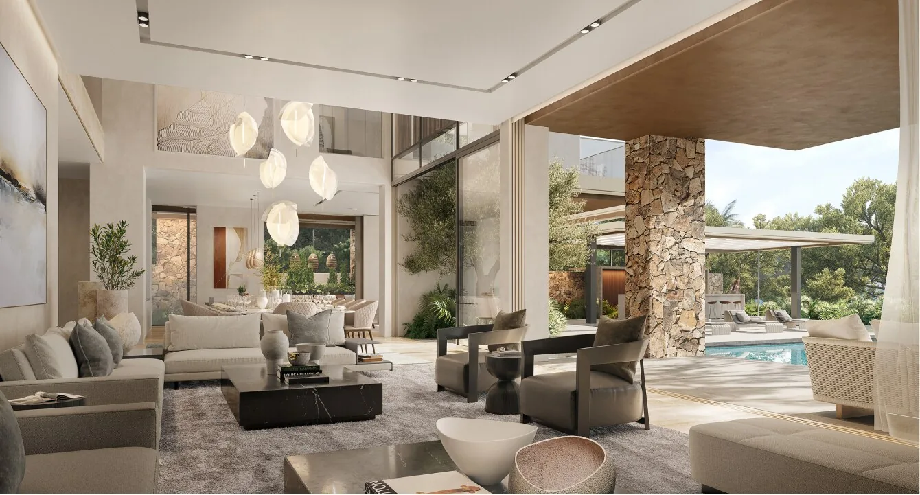 The great room at Alaya Beach, open to a stone-clad terrace and the pool beyond
