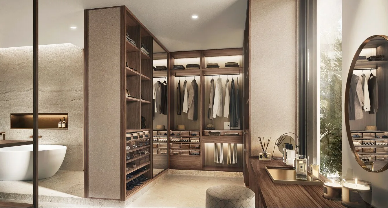Walk-in dressing room in the Terra palette at Alaya Beach, with walnut joinery beside the primary bathroom