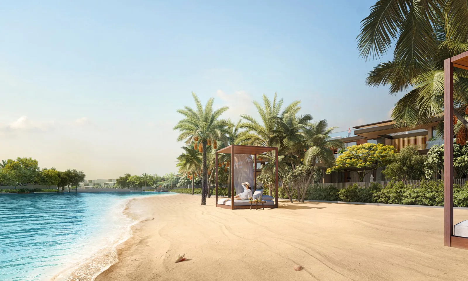The private sand beach on Lagoon Al Ghaf at Alaya Beach, with a shaded cabana and villas behind the palms