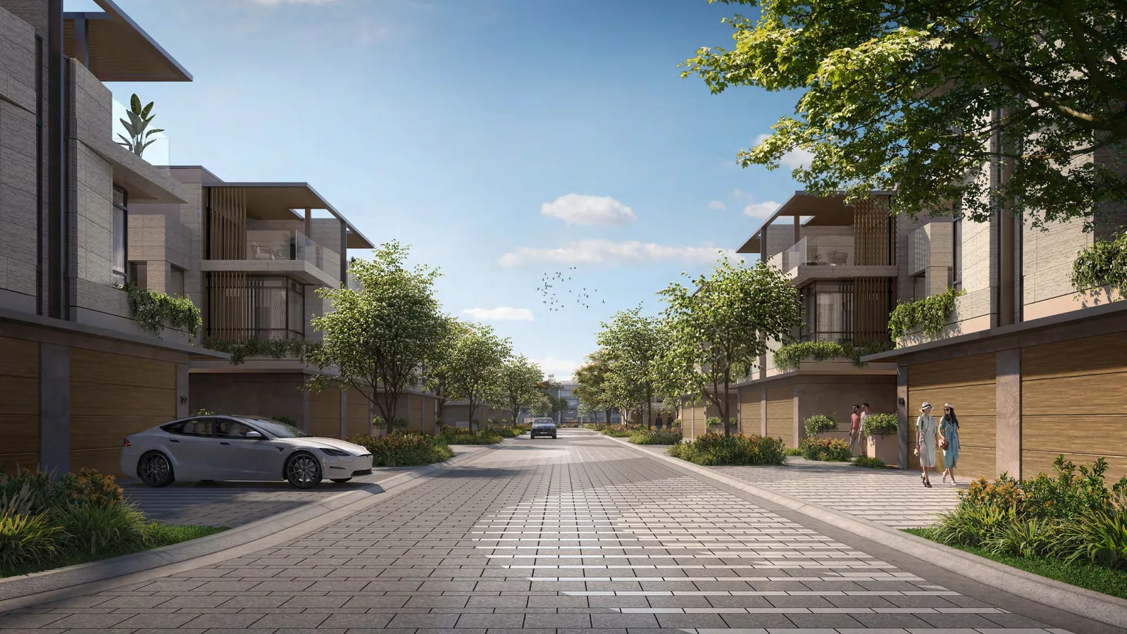 Street of Amara twin villas at Tilal Al Ghaf, lined with trees