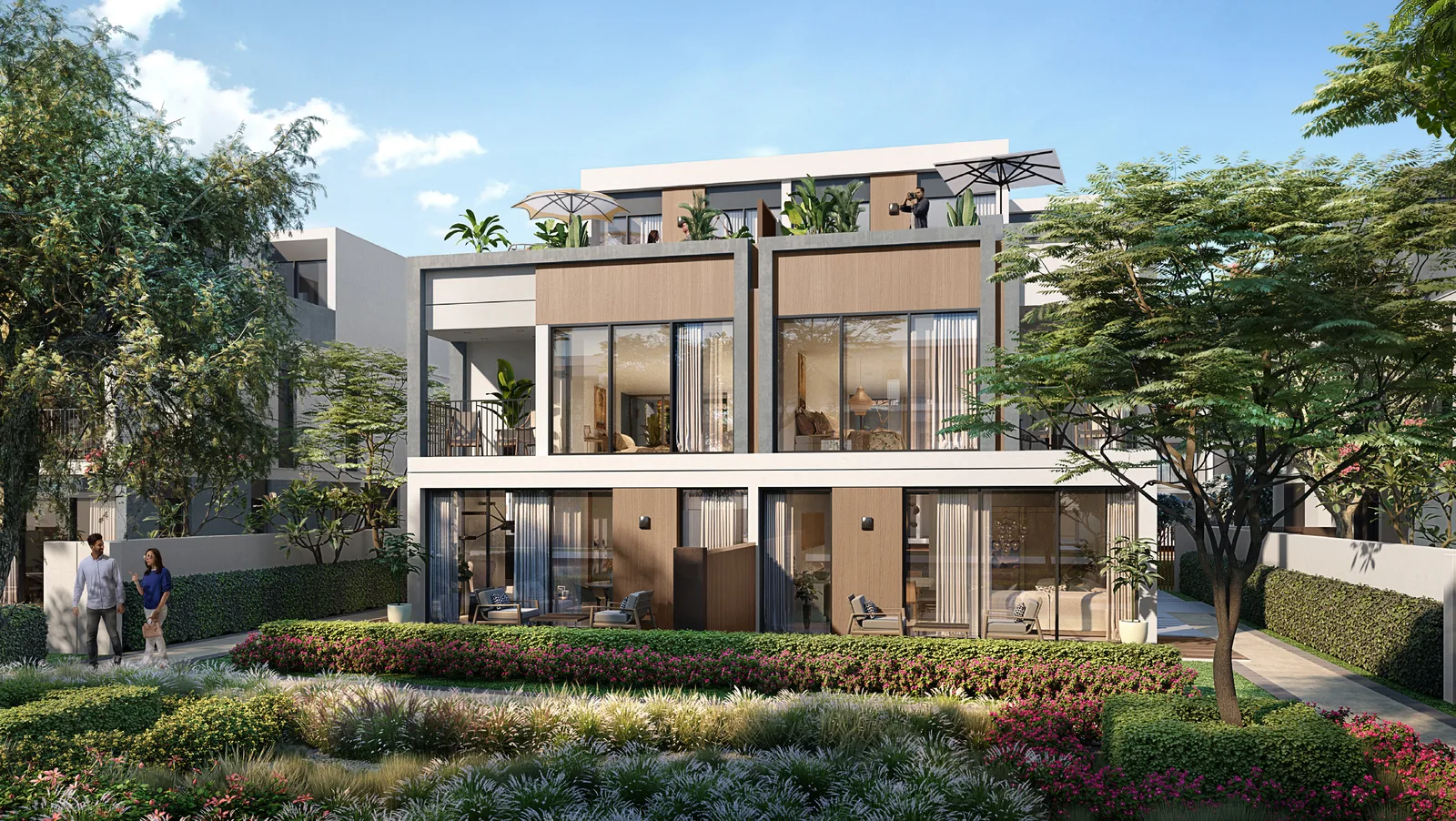 Rear elevation of an Aura twin villa at Tilal Al Ghaf with full height glass opening to the private garden and a planted roof terrace above