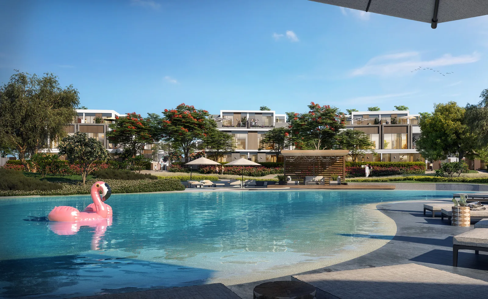 Recreational lagoon at Tilal Al Ghaf with white sandy beach and villas along the shoreline