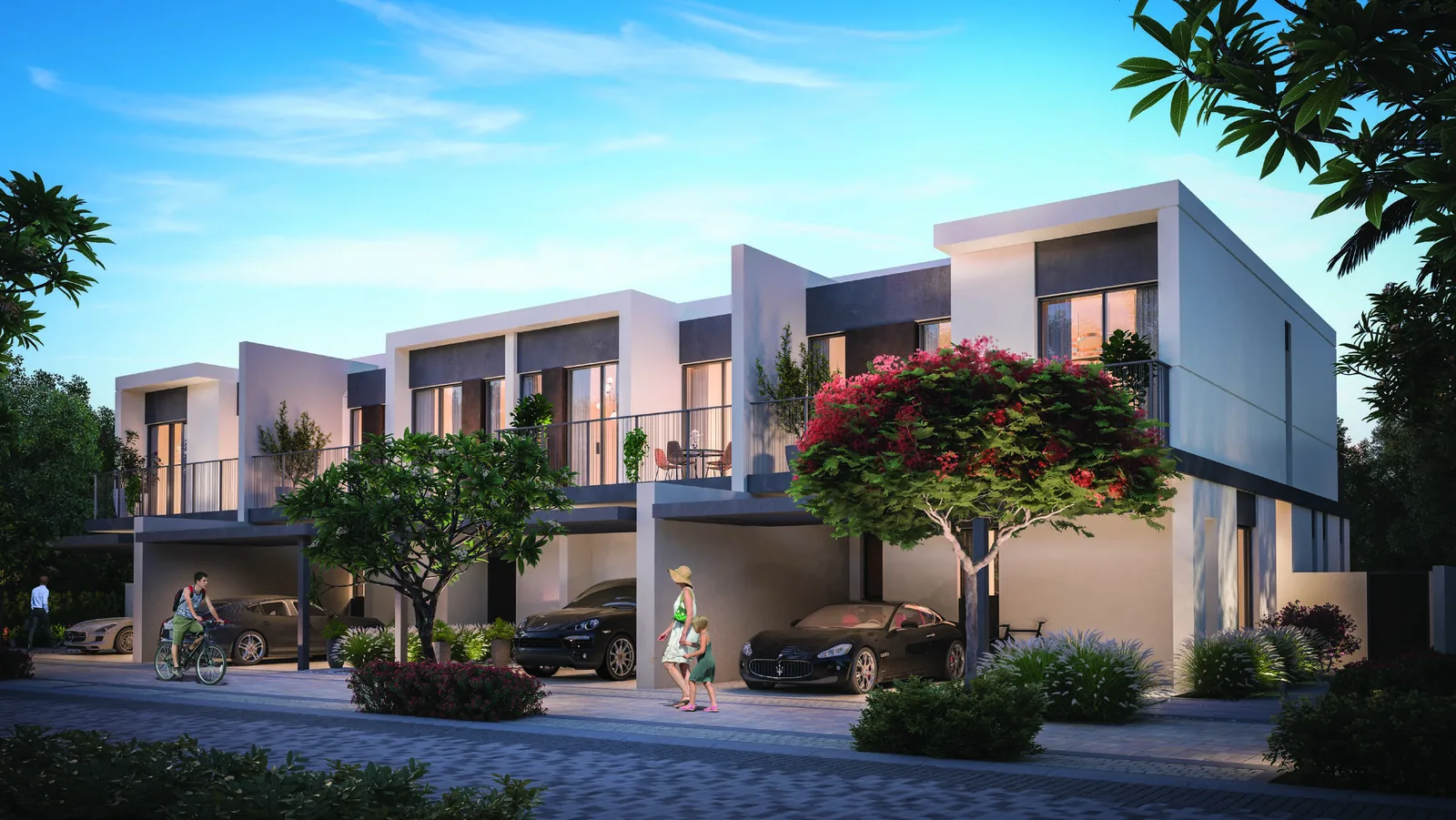 Street facade of Elan duplex townhouses with a two car driveway at Tilal Al Ghaf